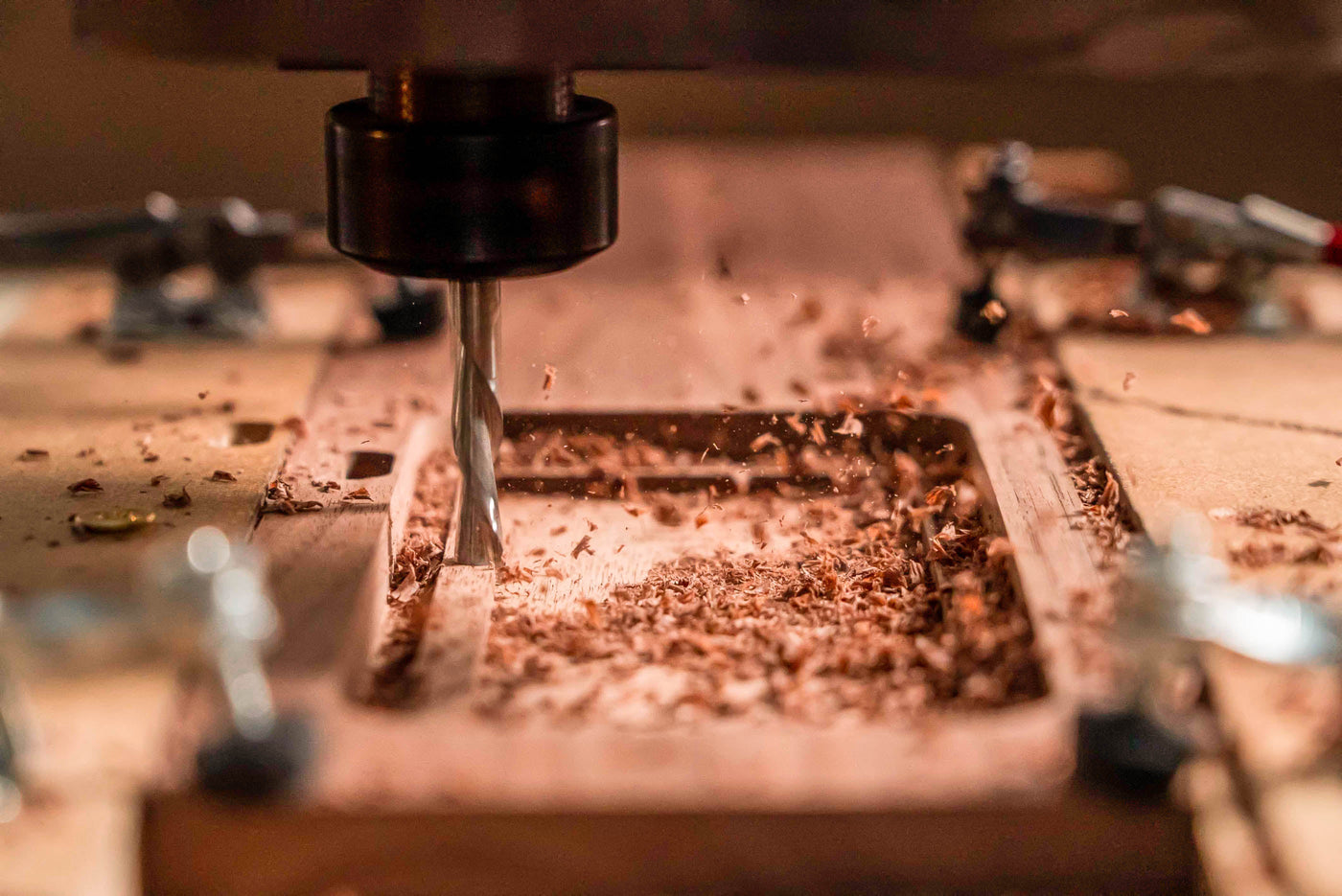 cnc router bit cutting wood for a wooden iphone case