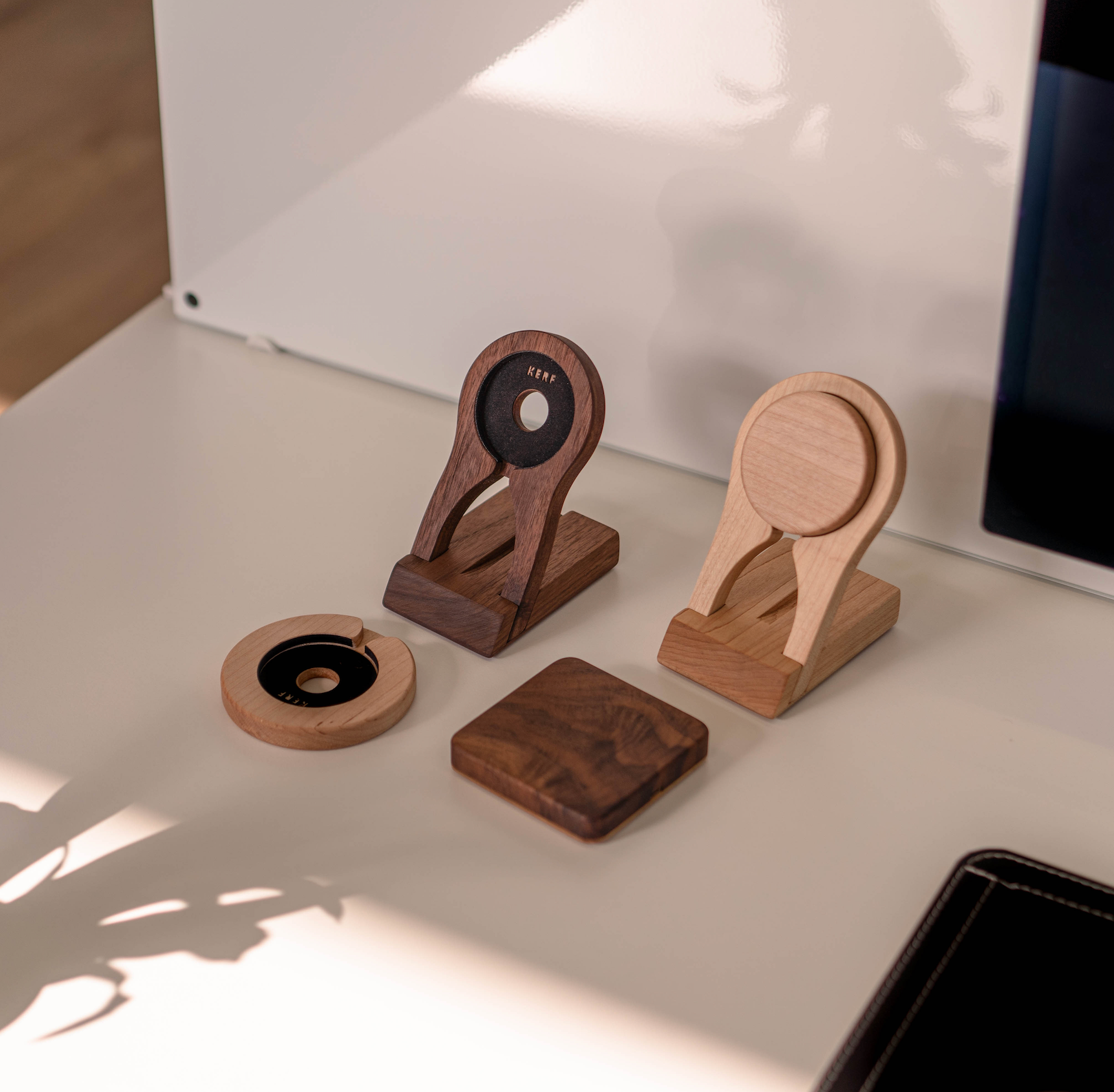 a collection of wooden wireless charging pads, docks and stands on a white background