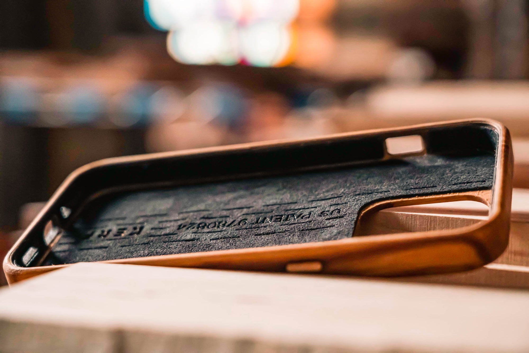 a photo of the interior lining of a wooden phone case showing the plant based suede.