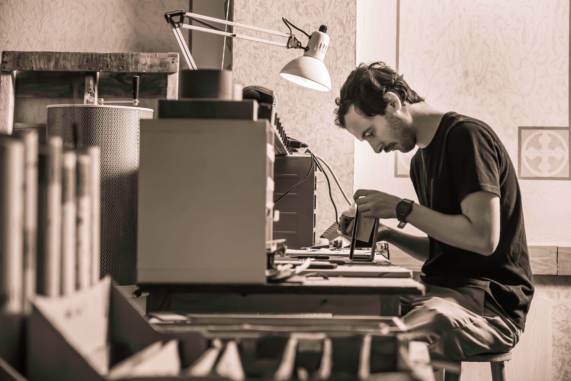 Photo of Seth Gamson working at the repair bench