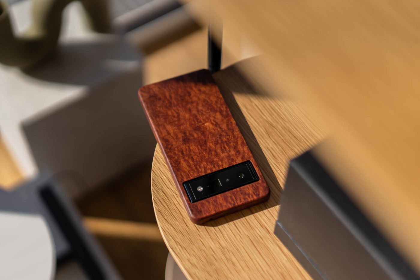 a Lacey Sheoak wooden pixel case sitting on a table 