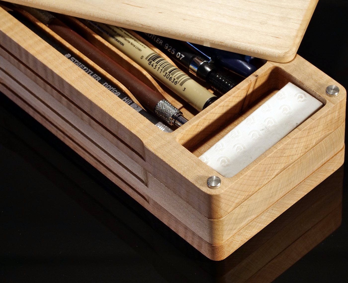 a KerfCase Studio Case - pencil case partly open showing neatly organized writing tools inside